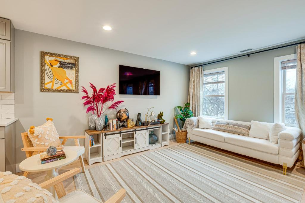 a living room with a couch and a table at Luxury Condo, Steps to Downtown Montclair and Train! in Montclair