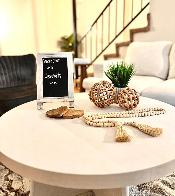 a white coffee table with a sign on it at Fondren Summer Getaway 5 Minutes to Major Hospitals in Jackson