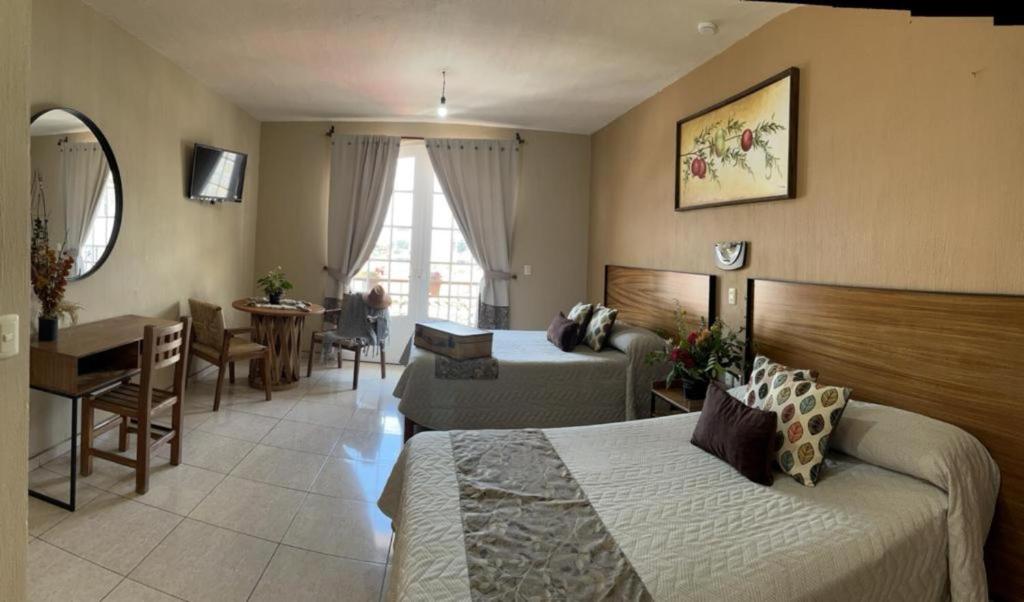 Postel nebo postele na pokoji v ubytování Hotel el Leñador