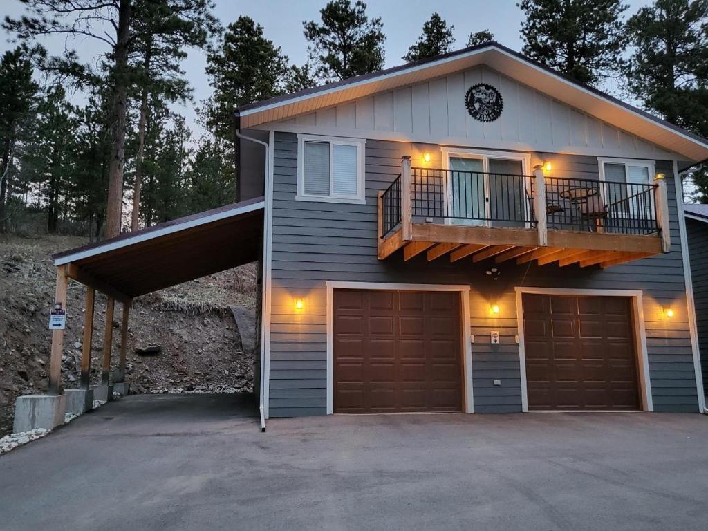 a house with a balcony and a garage at Thunder Ridge Loft in Lead