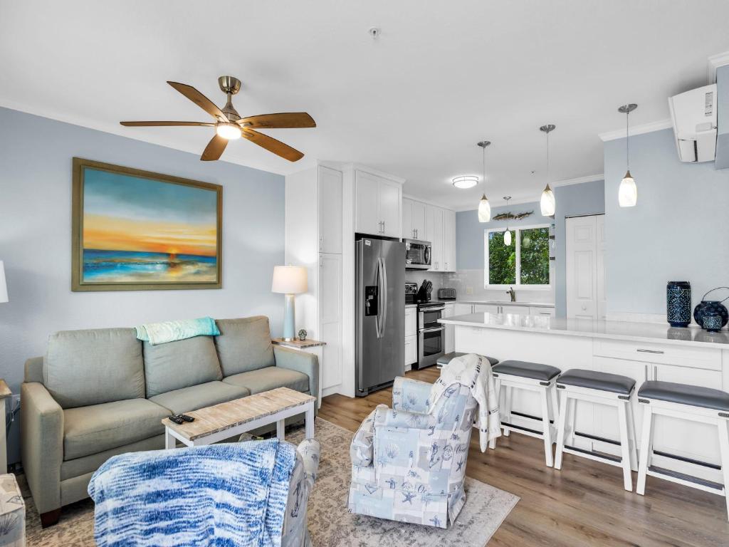 a living room with a couch and a kitchen at Atlantic Breeze NEW 1Bed 2Bath Condo in Marathon
