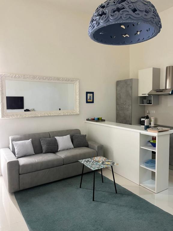 a living room with a couch and a table at Residenza Santi ai Monti in Rome