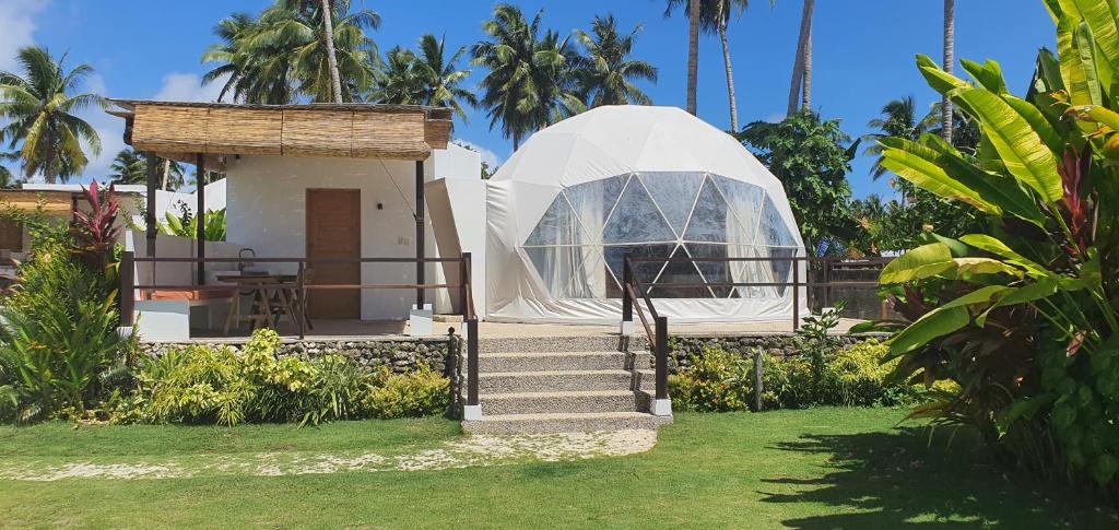 a house with a glass dome in a yard at Malipaya Villas in General Luna