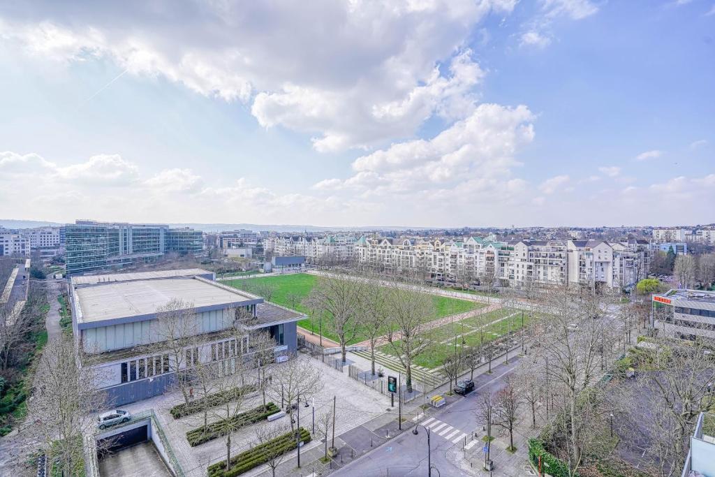 an aerial view of a city with buildings and trees at Grand appartement avec belle vue Paris in Rueil-Malmaison
