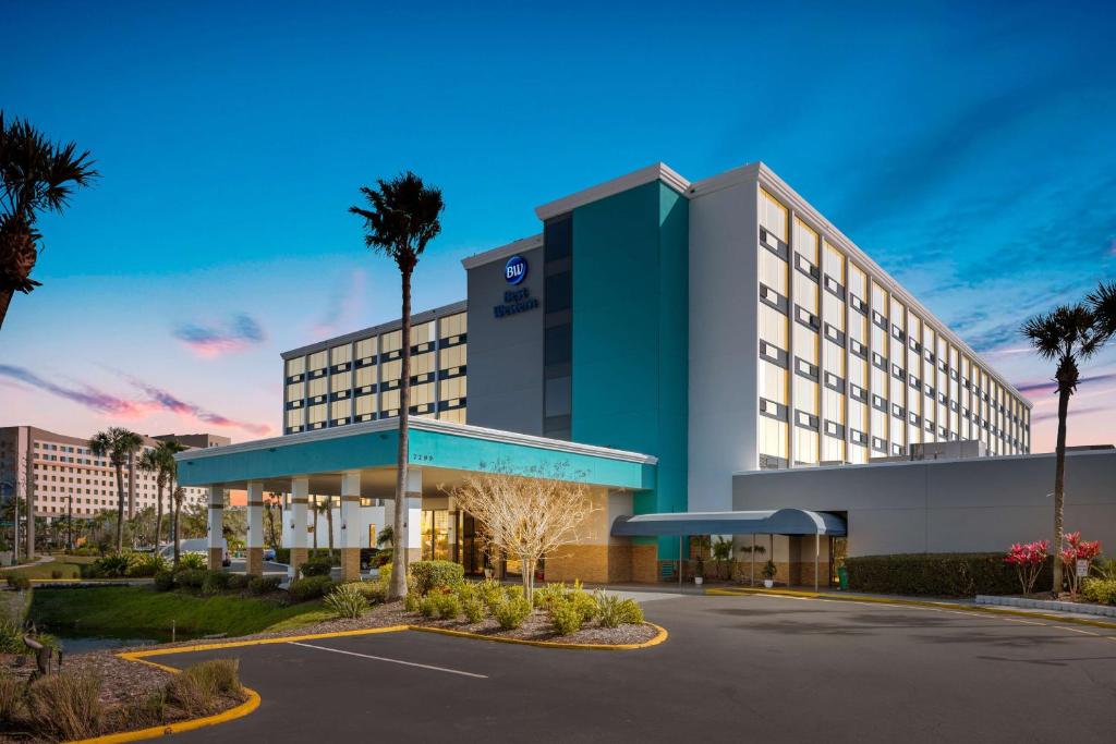 a rendering of a hotel with a parking lot at Best Western Orlando Gateway Hotel in Orlando