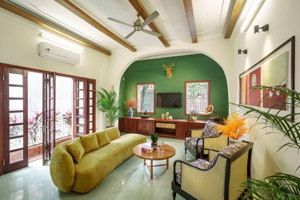 ein Wohnzimmer mit einem Sofa und einem Tisch in der Unterkunft Entire 3BR house 3 baths & patio Hoan Kiem Dist in Đà Nẵng