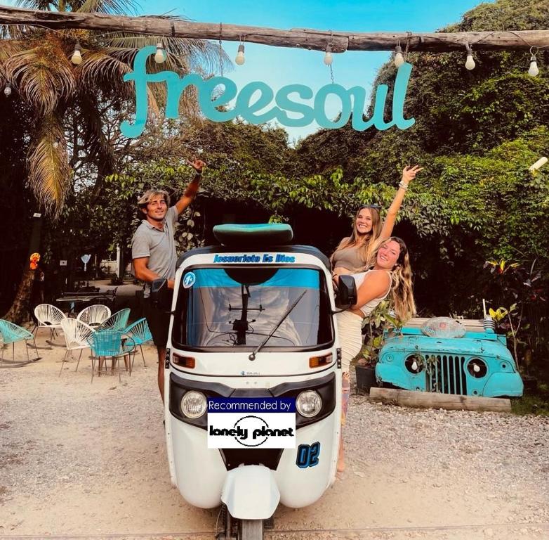 a group of people standing next to a small car at Freesoul Hostel in Palomino