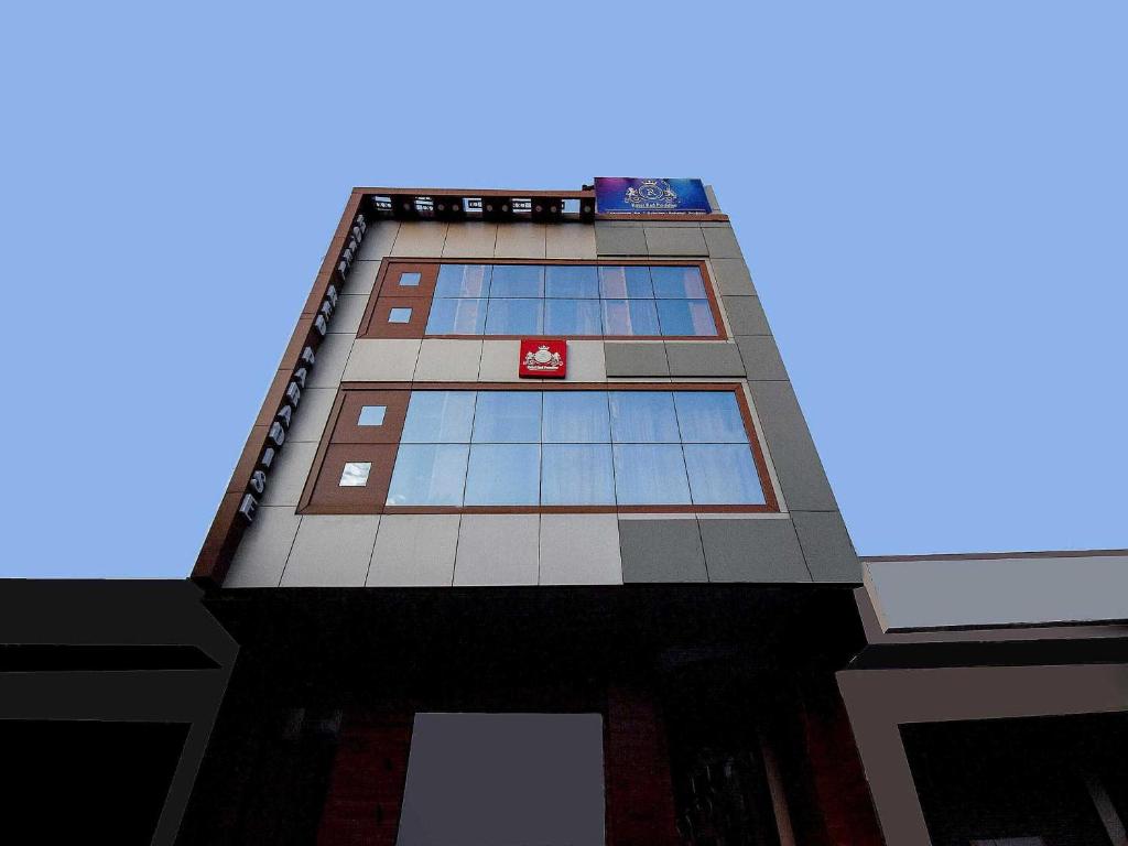 a tall building with blue windows on top of it at Collection O Red Paradise in Zirakpur