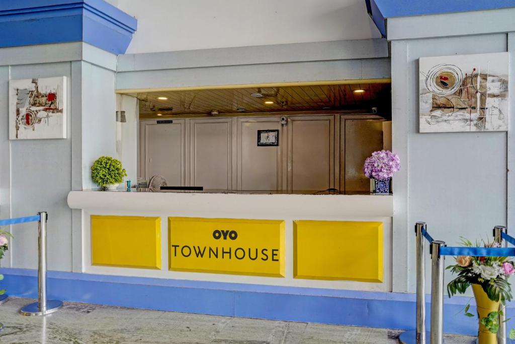 a yellow counter in a kitchen with a top wowoice sign at Townhouse Royal Palms Hotel - Lily in Mumbai