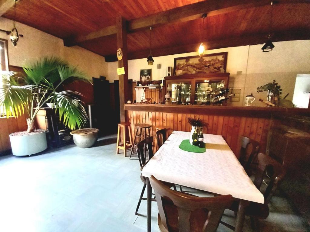 a restaurant with a table and chairs and a bar at Holiday home in Saint Quirin with garden in Saint-Quirin
