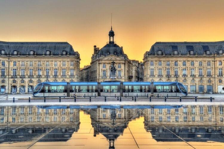 a building with a reflection in the water in front of it at holiday home, Grayan-et-l&#39;Hôpital in Grayan-et-lʼHôpital