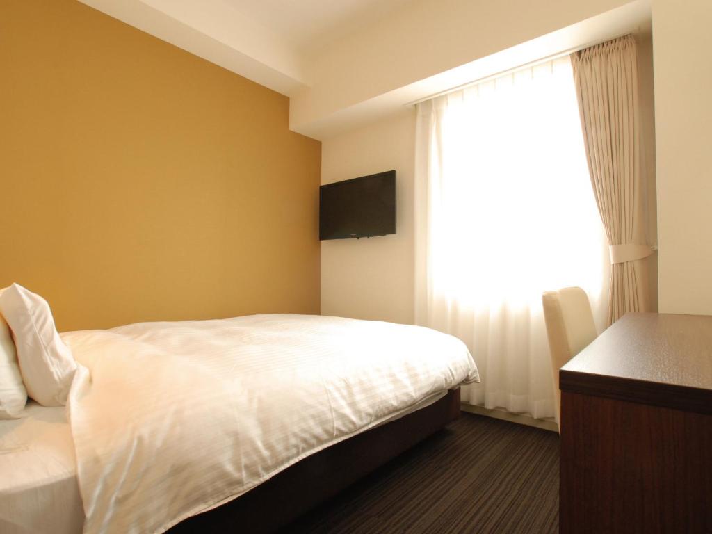 Postel nebo postele na pokoji v ubytování AB Hotel Fukaya