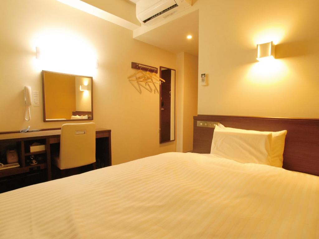 Postel nebo postele na pokoji v ubytování AB Hotel Fukaya