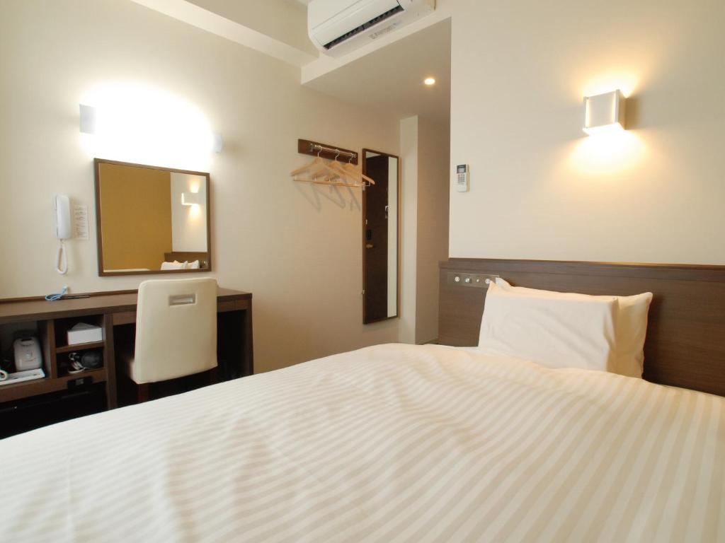Postel nebo postele na pokoji v ubytování AB Hotel Fukaya