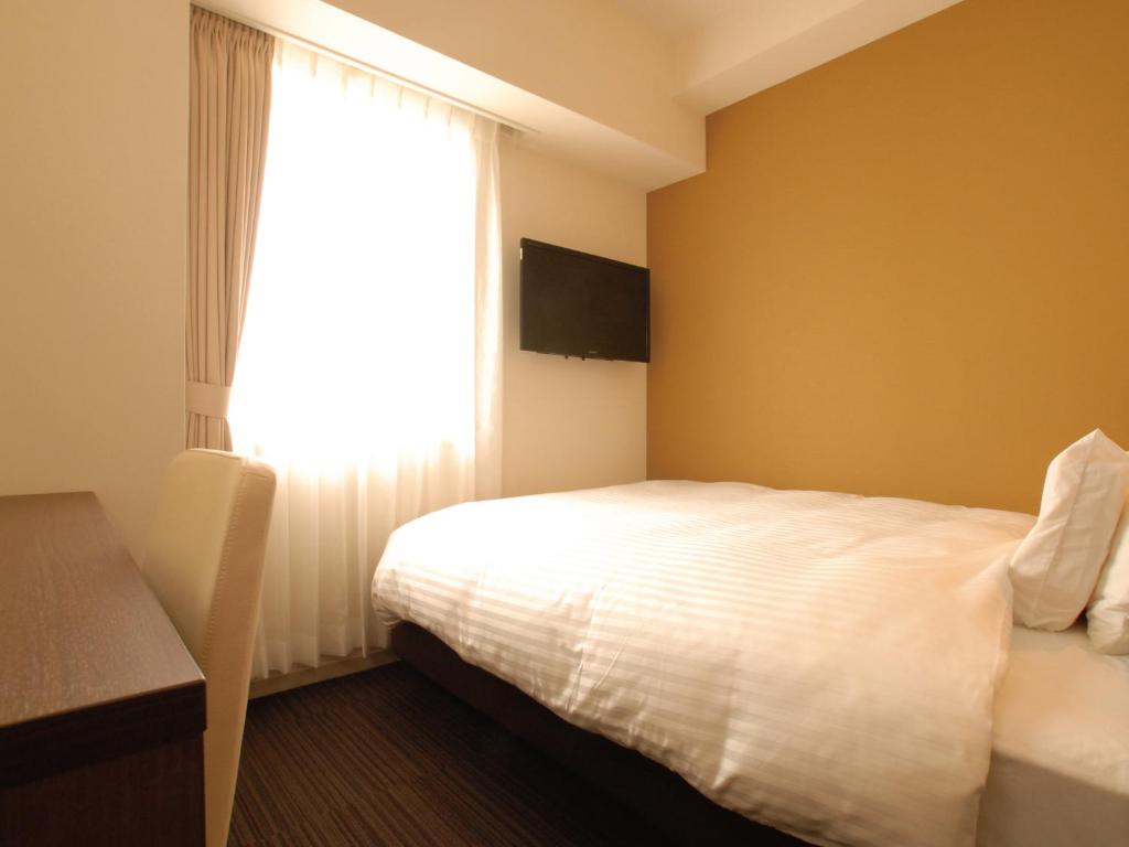 Postel nebo postele na pokoji v ubytování AB Hotel Fukaya