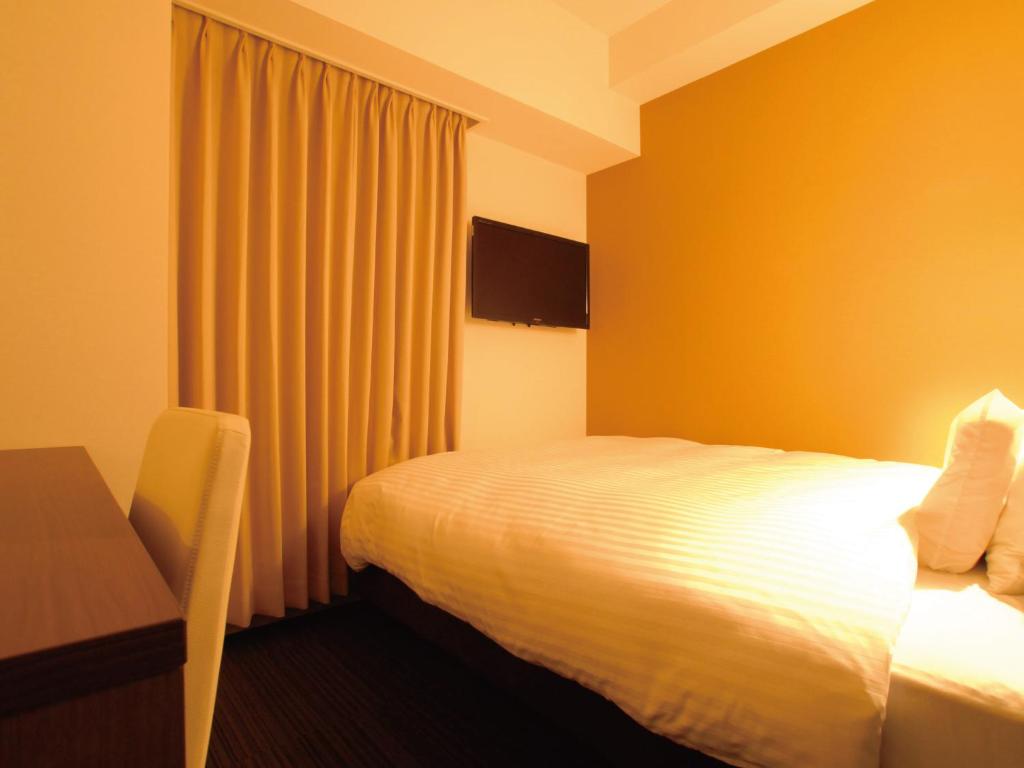 Postel nebo postele na pokoji v ubytování AB Hotel Fukaya