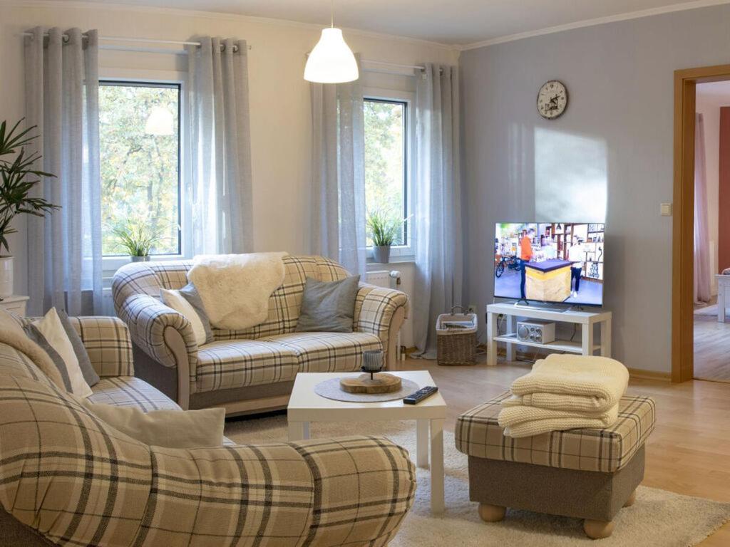 a living room with two couches and a tv at Apartment in the Eichengrund in Häcklingen