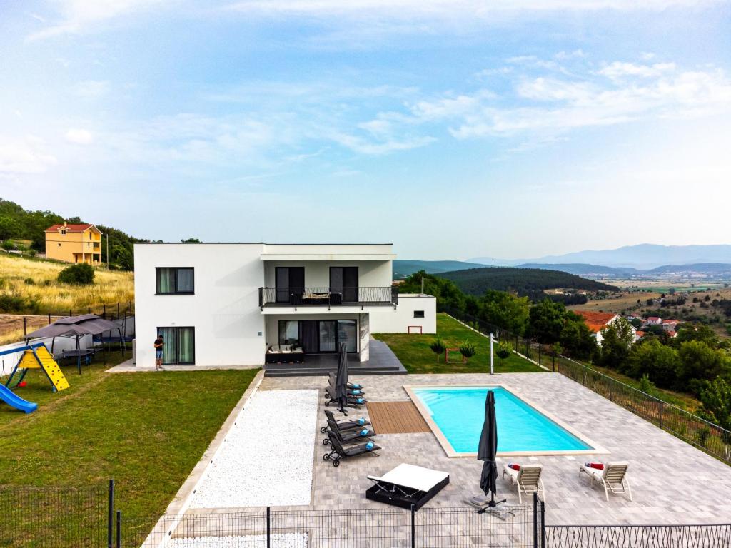 a villa with a swimming pool on a hill at Family friendly house with a swimming pool Otok, Zagora - 22669 in Otok