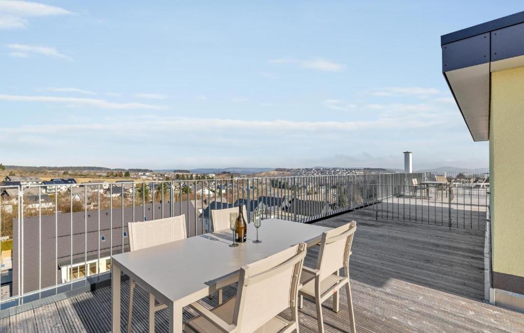 a patio with a table and chairs on a balcony at Rundumblick in Winterberg