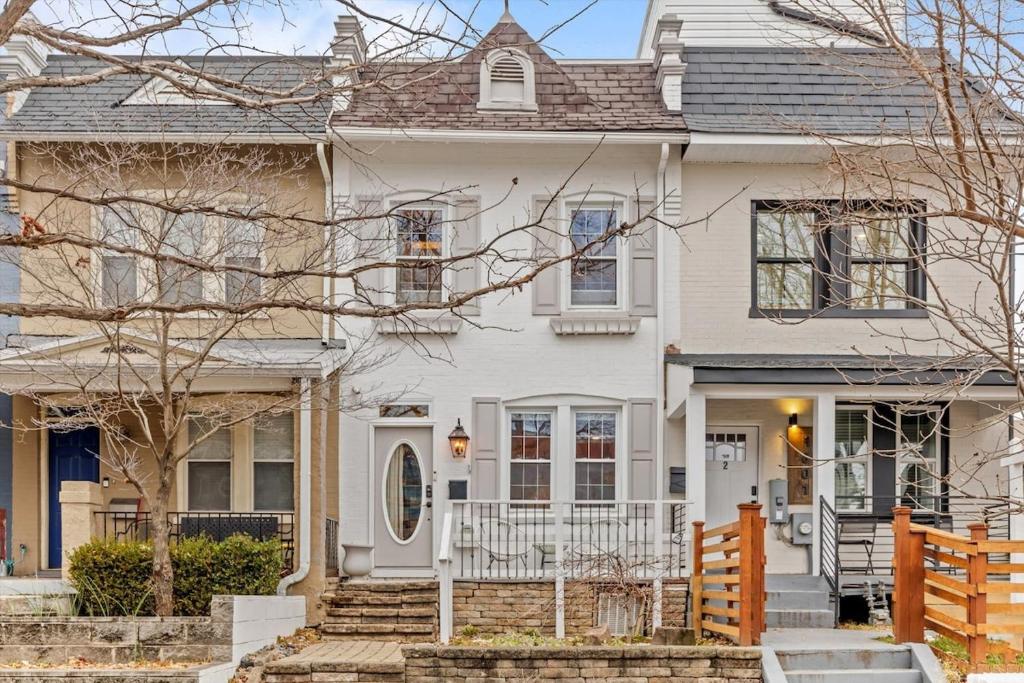 a white house with a porch and a fence at Columbia Heights Home METRO + Shopping + Parking in Washington