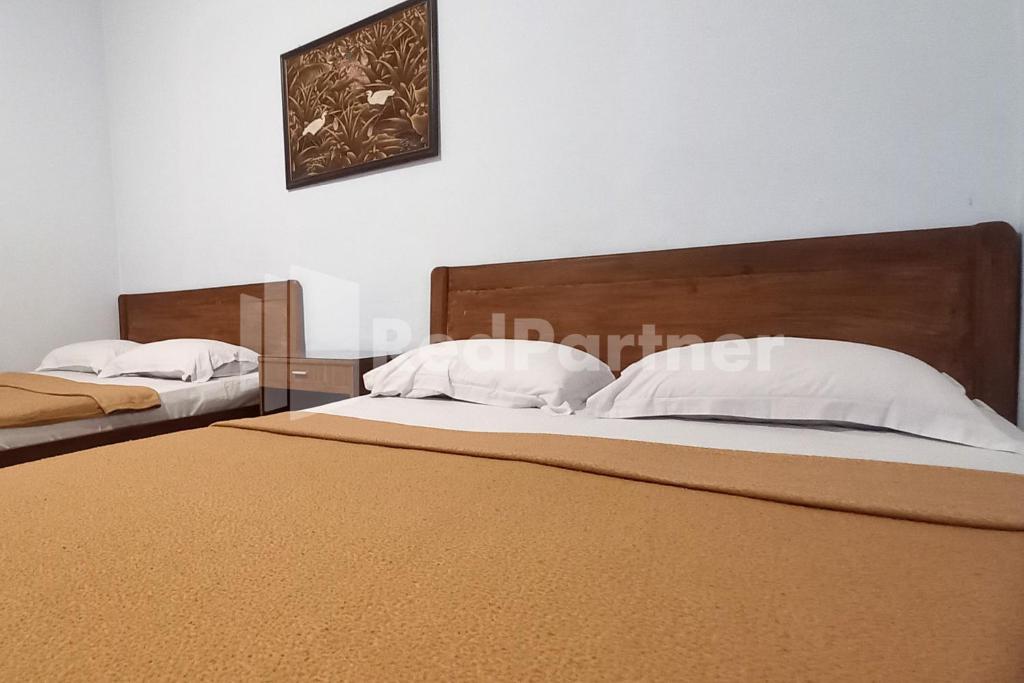 Postel nebo postele na pokoji v ubytování Hotel Palem 1 Syariah RedPartner