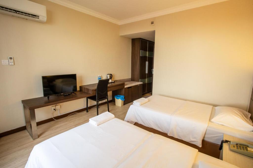 Postel nebo postele na pokoji v ubytování Somerset Hotel