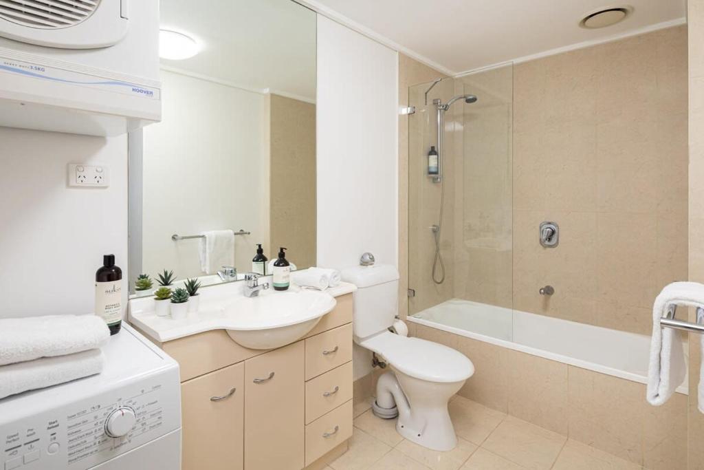 a bathroom with a sink and a toilet and a shower at Melbourne CBD Apt With A C Balcony & Pool in Melbourne
