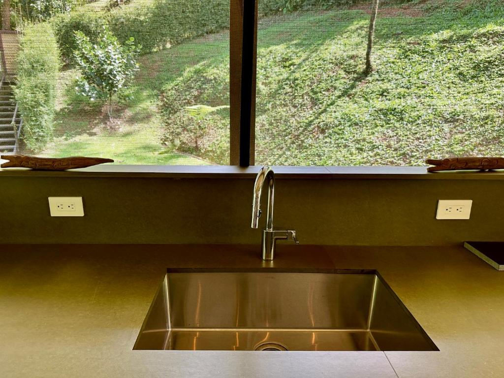 a kitchen sink in front of a window at Arbol De La Vida at La Alfombra de Baru 