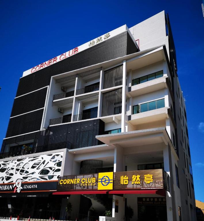a building with a sign on the side of it at Corner Club Penang in George Town
