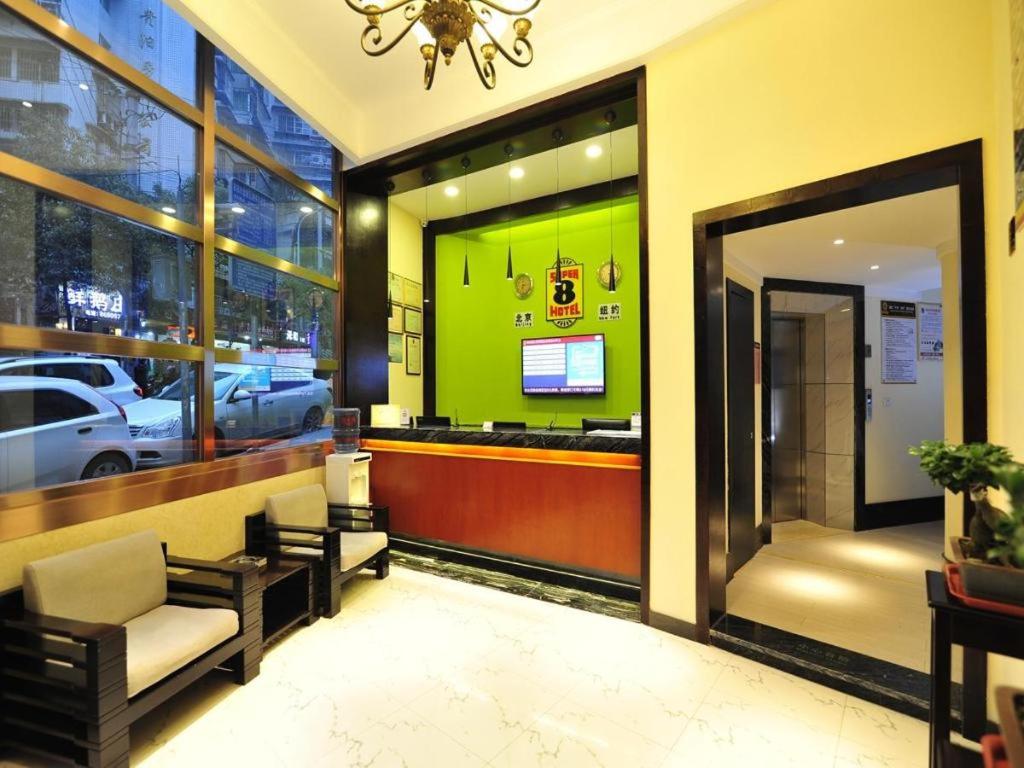 a lobby with a waiting area with a car salon at Super 8 Hotel Guiyang Qianling Park Ruijin North Road in Guiyang