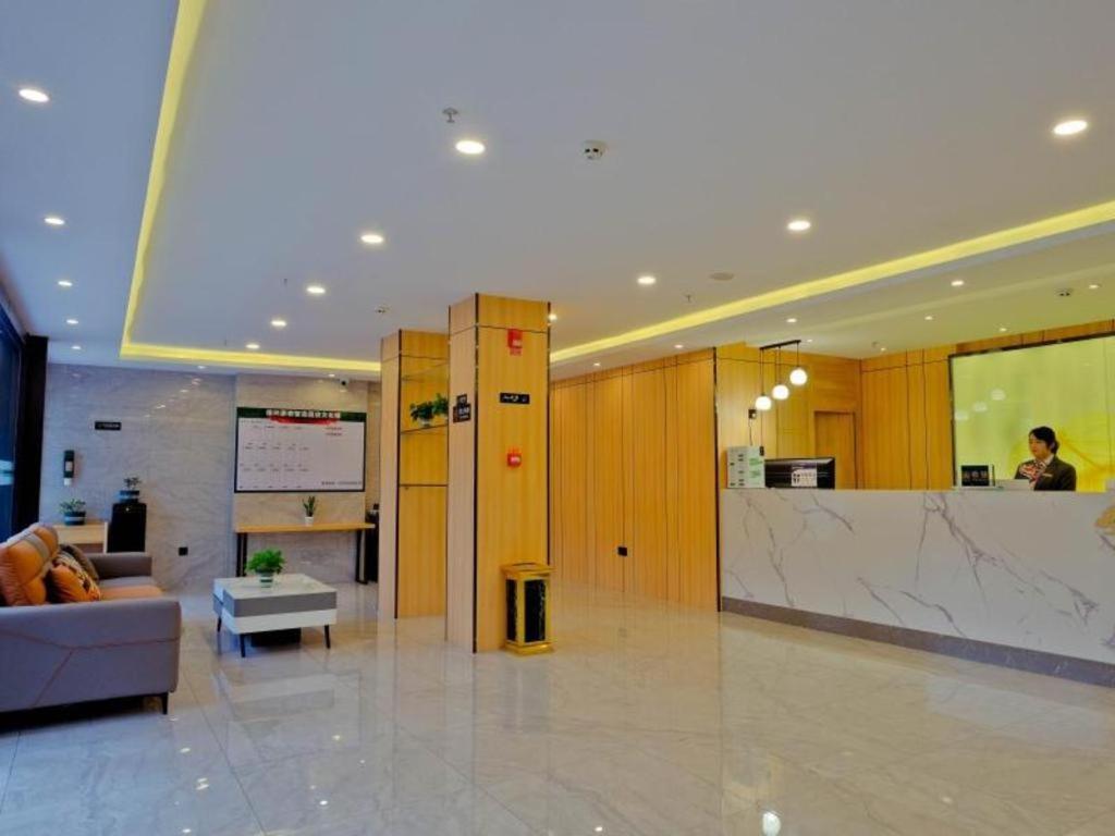 - un hall avec un canapé et un comptoir dans un bâtiment dans l'établissement Green Tree Inn Gansu Tianshui Qinzhou District Tianshui Wanda Plaza, à Tianshui