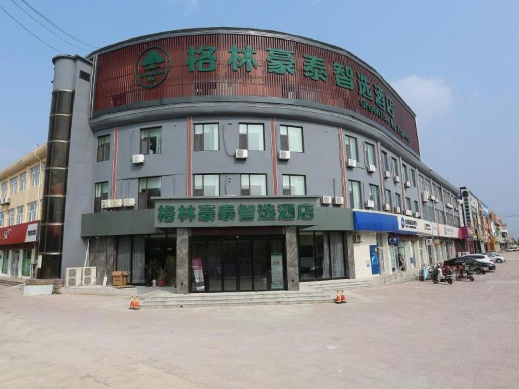a large building with writing on the side of it at Green Tree Inn Shandong Dongying Lijin County Phoenix Plaza in Litsinghsien