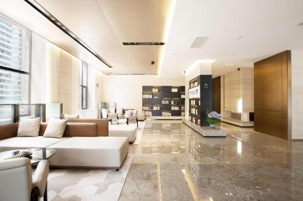 a lobby with couches and chairs in a building at Atour Hotel Shenyang Heping Street Dongbei University in Shenyang