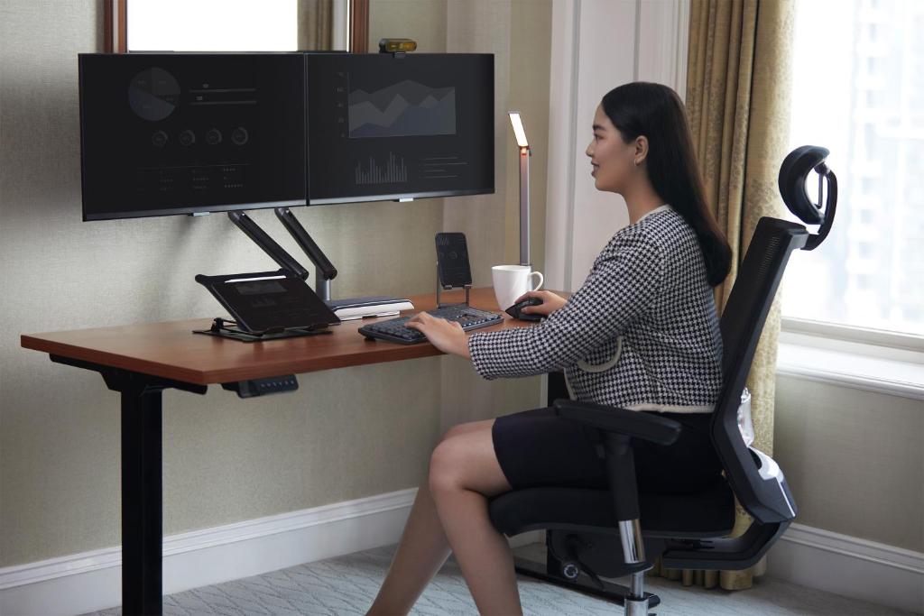 a woman sitting at a desk with a computer at Shangri-La Jakarta in Jakarta