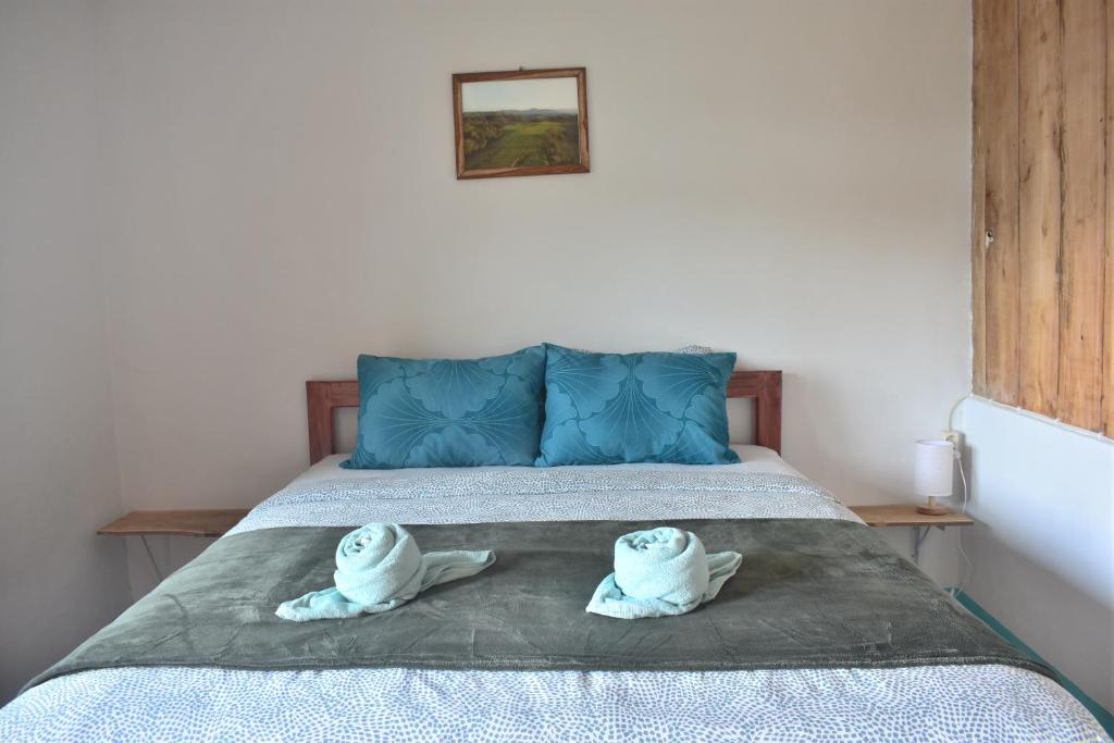 a bedroom with a bed with two towels on it at Mama's Homestay Ruteng in Ruteng