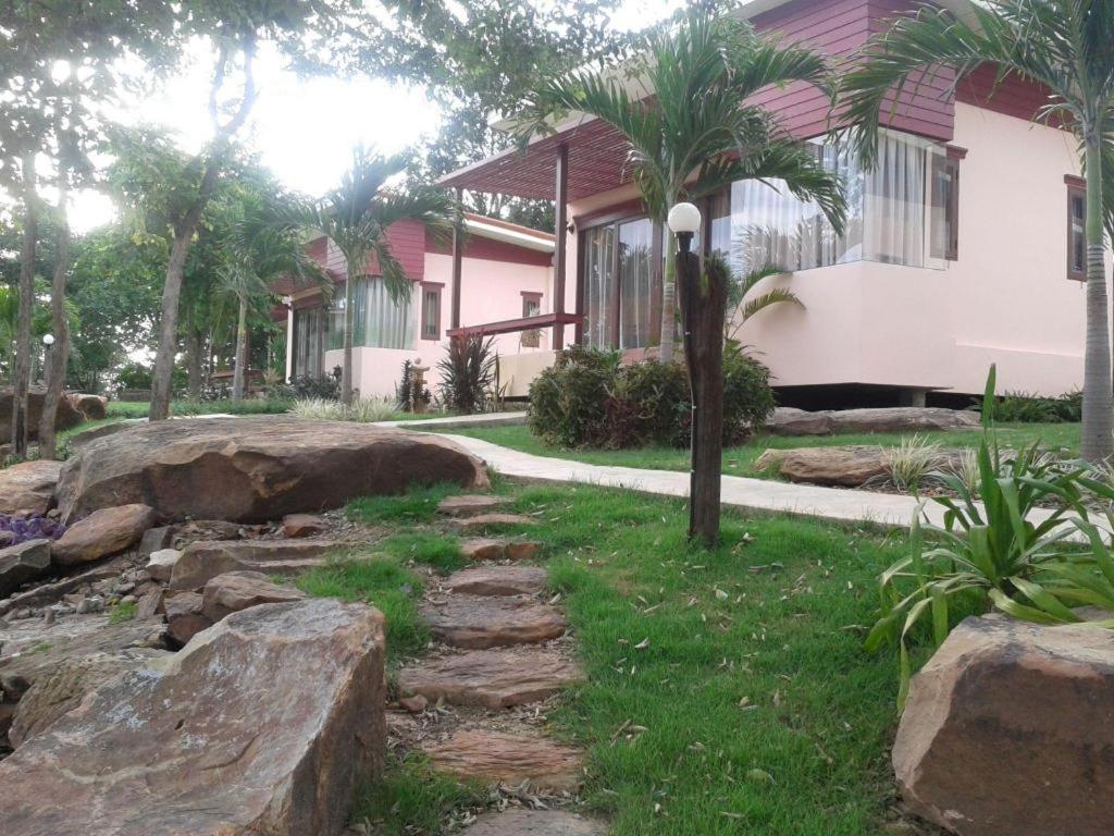 a house with a stone path in front of a house at Raisubsomboon Resort in Ban Don Wan