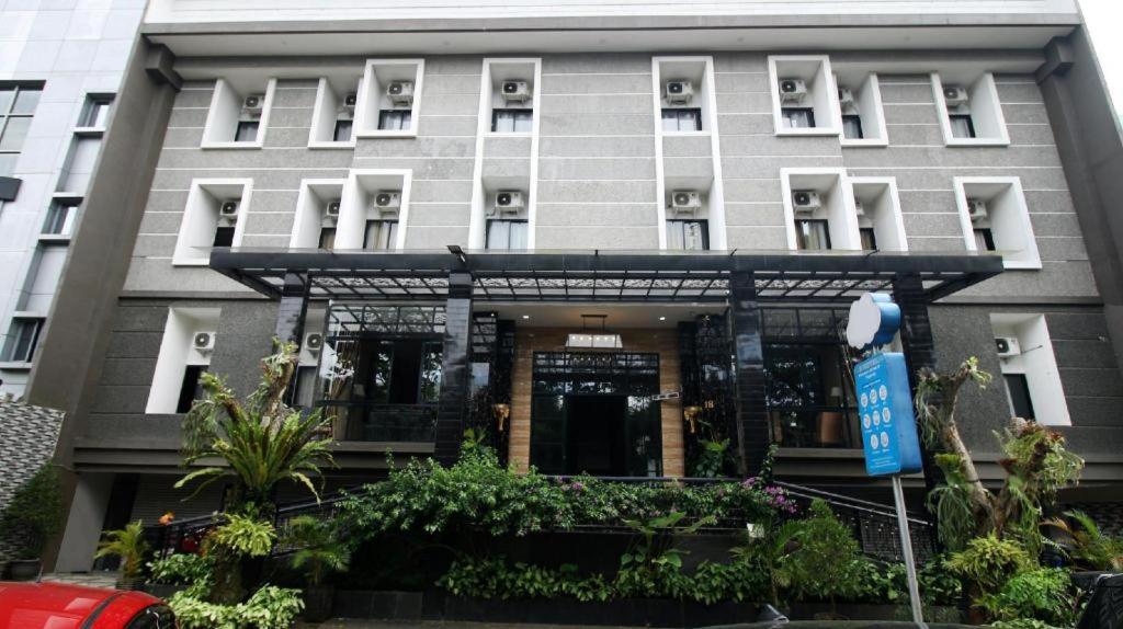 a large gray building with plants in front of it at Arotel BSD in Tangerang