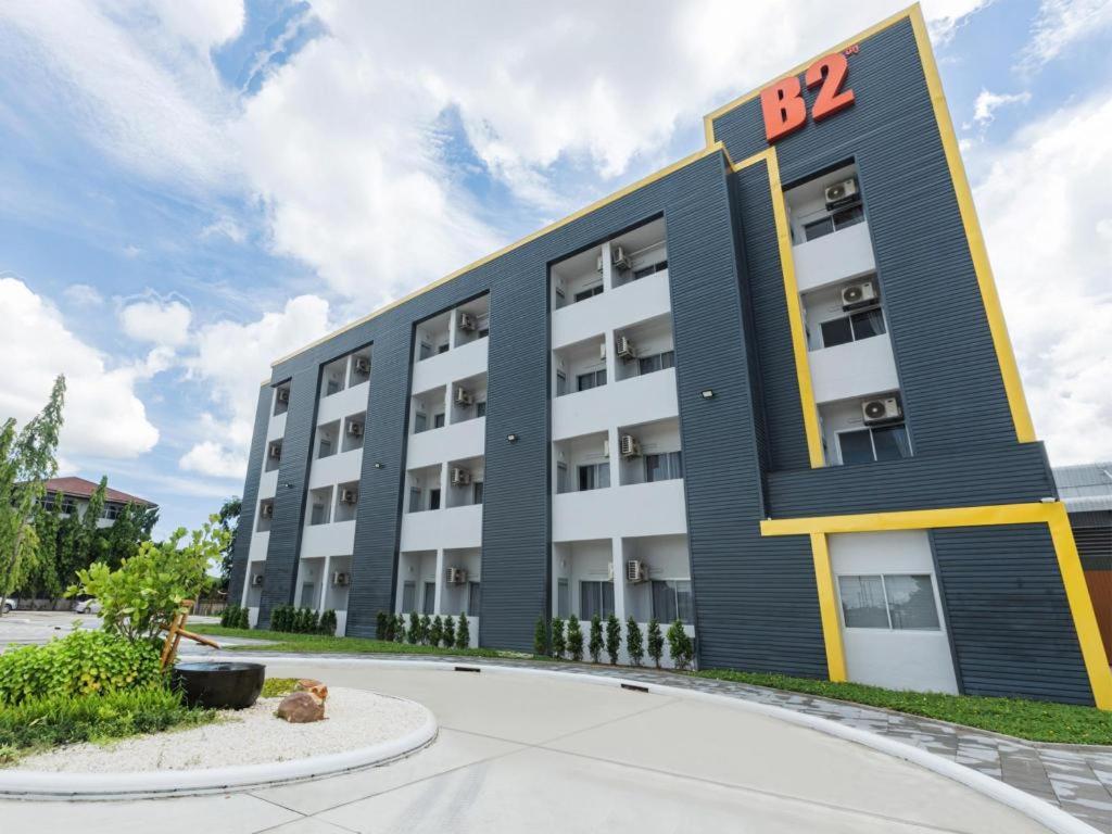 an apartment building with the sign on it at B2 Map Ta Phut Boutique & Budget Hotel in Ban Huai Pong