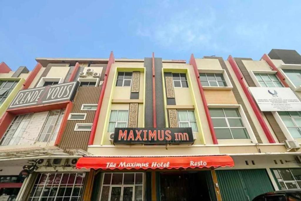 a large building with a maxmisimom sign on it at TwoSpaces Living at Maximus Inn in Sukarami