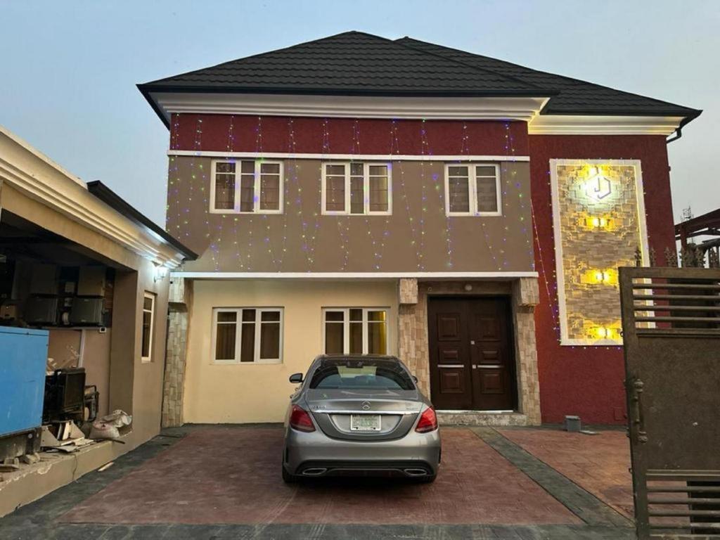 a car parked in front of a house at Juliet's Place Residence & Hotel in Eregun