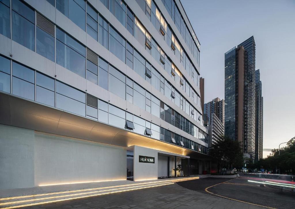 a tall building with a street in front of it at eLong Hotel (HUA Shenzhen Bay Branch) in Shenzhen