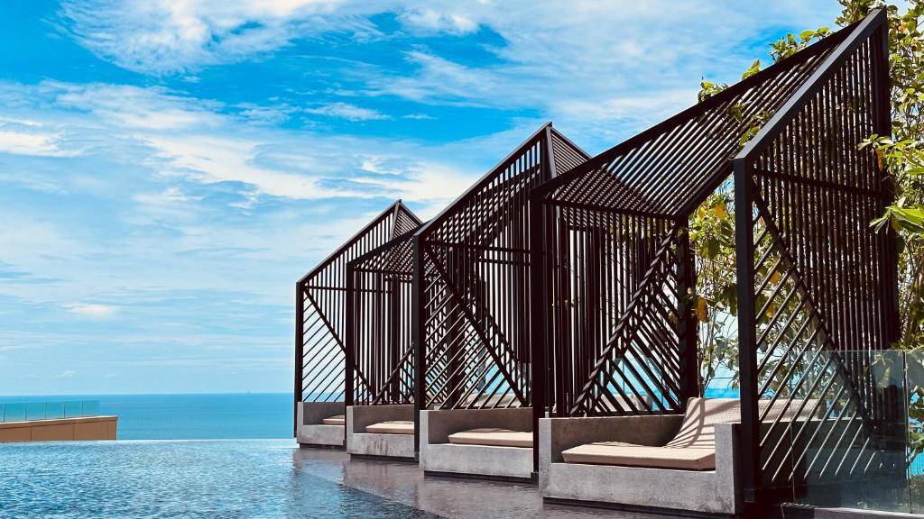 a group of benches on the edge of the water at the edge central holiday inn new in Pattaya