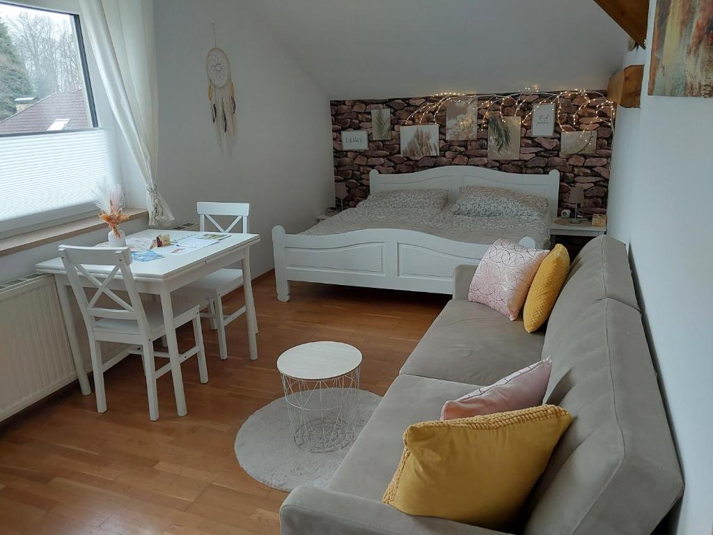 ein Wohnzimmer mit einem Sofa, einem Bett und einem Tisch in der Unterkunft HomeW4 - Apartment Sonnenschein in Hoheneich