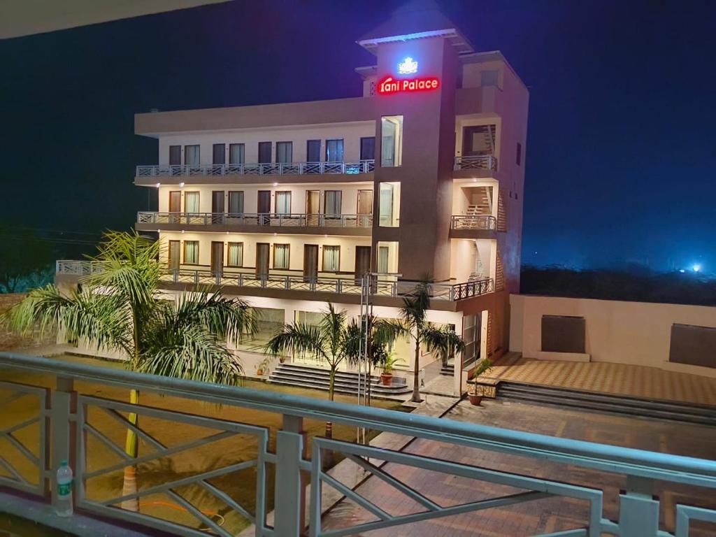 a building with a neon sign on it at night at Rani Palace Hotel And Resort in Kishangarh