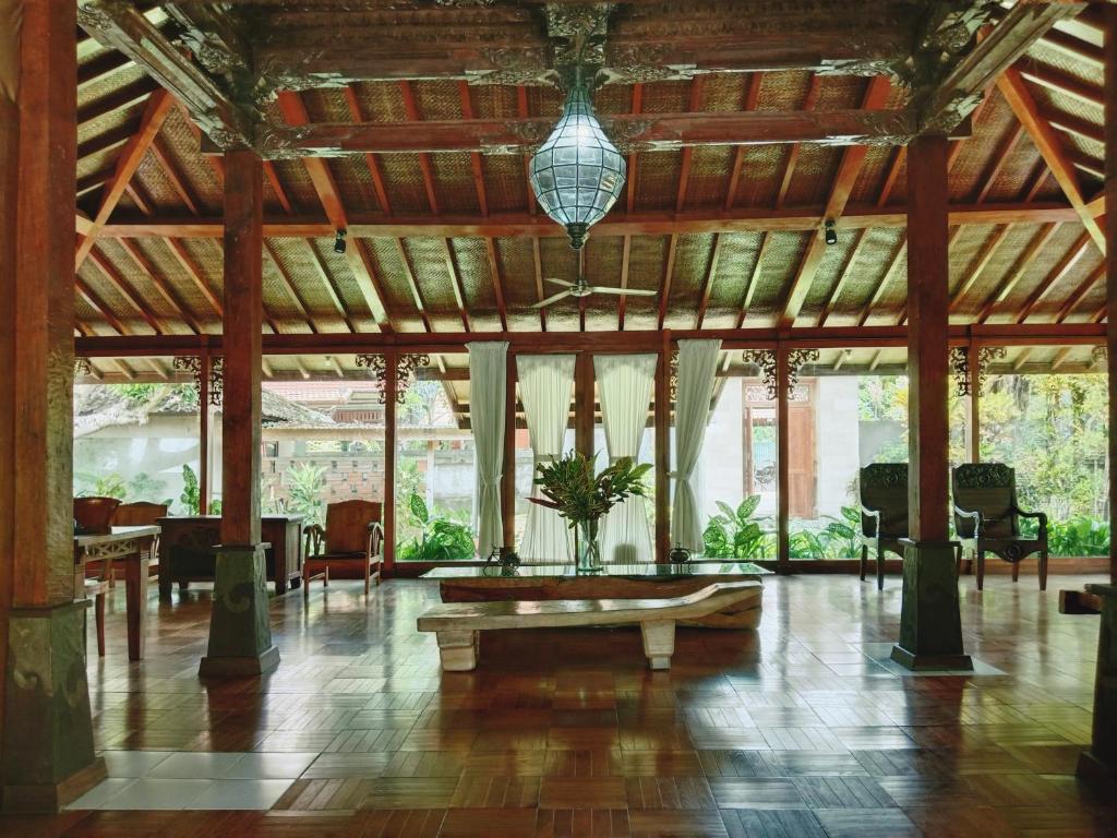 a large lobby with a table in the middle at Javanese Joglo House by Malathi Ubud in Ubud