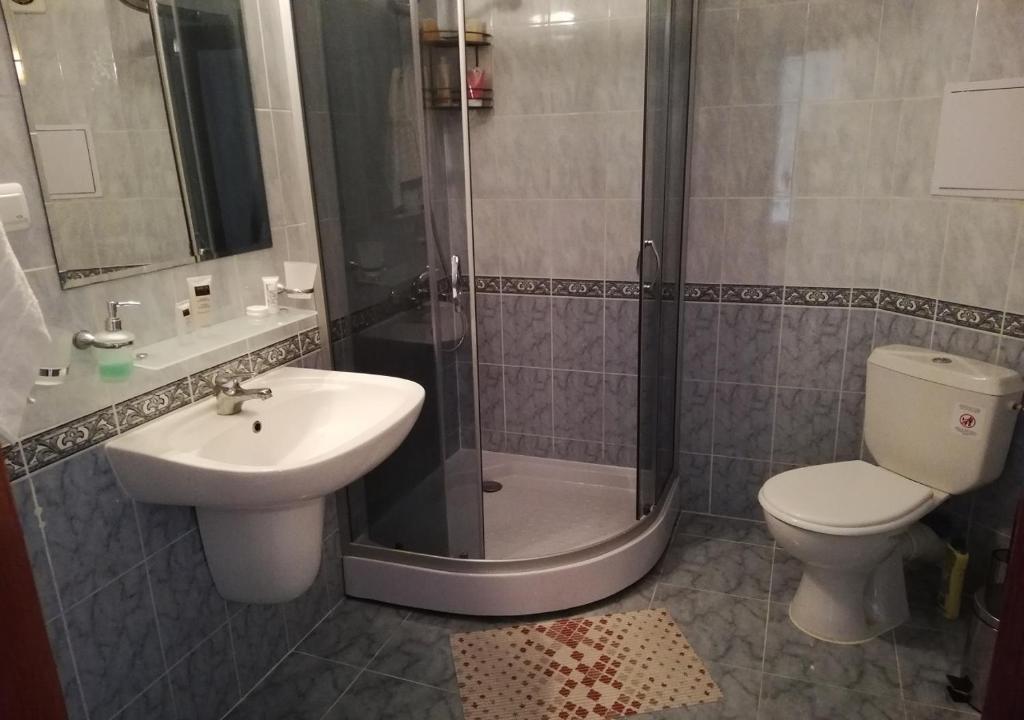 a bathroom with a shower and a toilet and a sink at Charis Cozy Family apart at Sun Village Complex close to the Beach in Sunny Beach