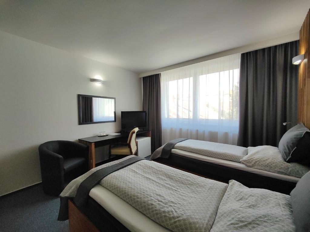 Voodi või voodid majutusasutuse Hotel P7 toas