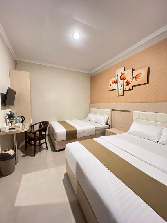 Postel nebo postele na pokoji v ubytování Ayuri Hotel Malioboro