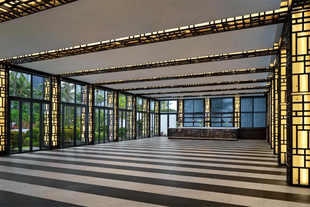 a large room with glass windows and ailed floor at Shangri-La Jakarta in Jakarta