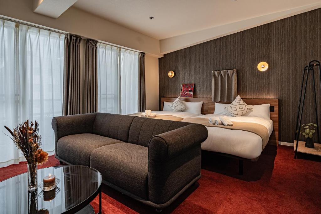 Postel nebo postele na pokoji v ubytování Apartment Hotel 11 Shinsaibashi Amemura